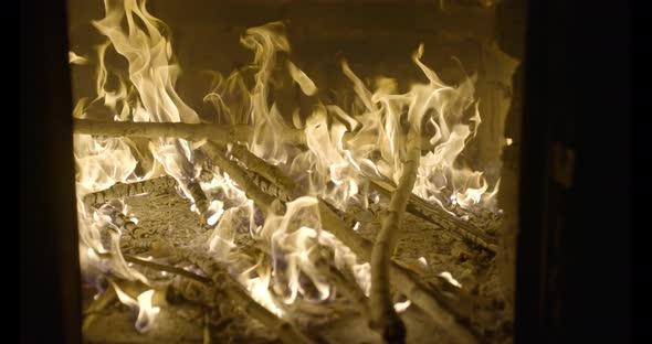 A wood is droped to start fire in a clay oven For cooking Traditional Italian Pizza 4K Slow motion alt