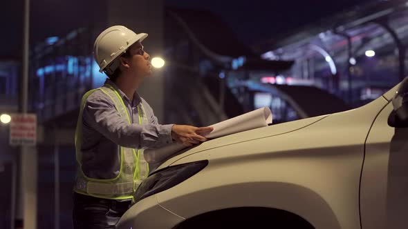 Civil engineer work inspecting architect drawing on construction site.