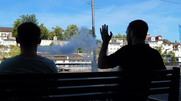 One man disturbes another smoking a vape. Disturbed man alt