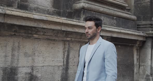 The Guy Walks Near The Old Building alt