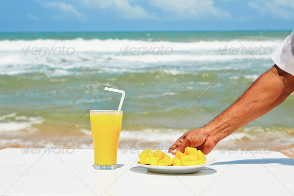 Fresh mango fruit and juice on the beach - Stock Photo - Images