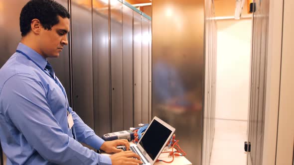 Technician working on laptop alt