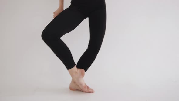 A Beautiful Young Girl Smoothly Moves During Stretching Classes in the Studio and Does a Vertical