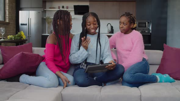 Positive African Adolescent Girl Video Conferencing with Tablet Pc alt