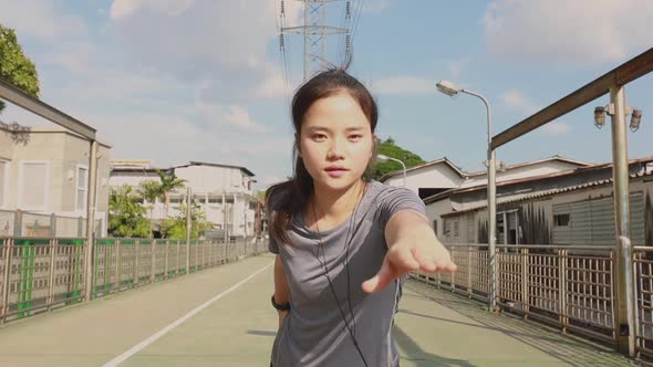 Athlete young Asian woman stretching legs and warming before running.