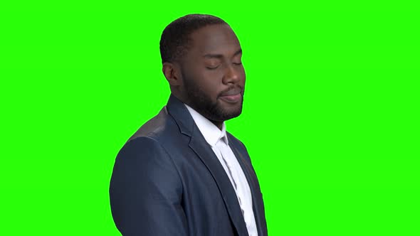 Flirtatious Afro-american Businessman on Green Screen. alt