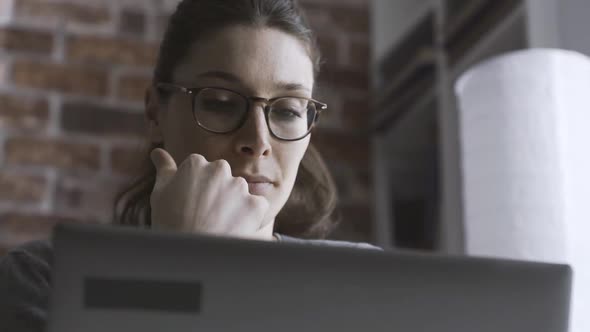 Woman working with her laptop at home