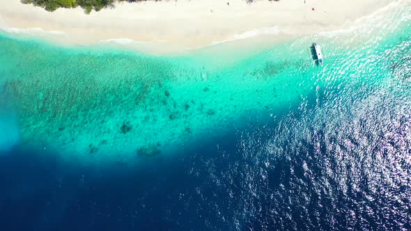 Daytime Above Travel Shot of A White Sand Paradise Beach and Blue Ocean Background alt