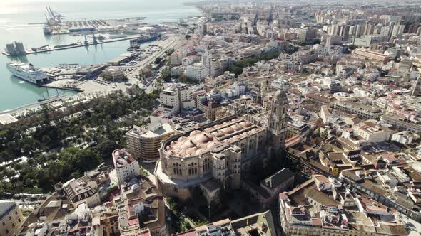 Cathedral of Incarnation in Malaga historic center with touristic port in background, Spain. Aerial