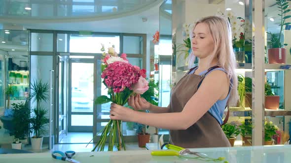 Young Florist Holds Flower Stalks Making Bright Bouquet alt