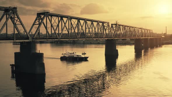 Dramatic Yellow Sunset Over River Bridge Industrial Landscape