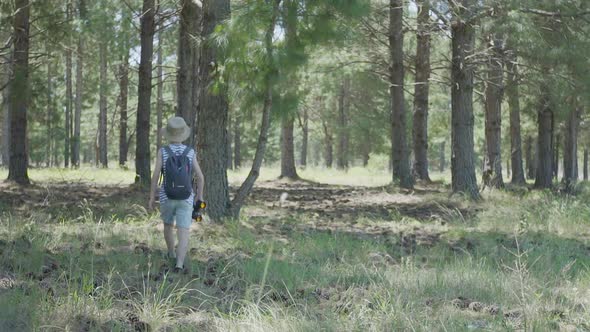 Boy exploring in woods with binoculars alt