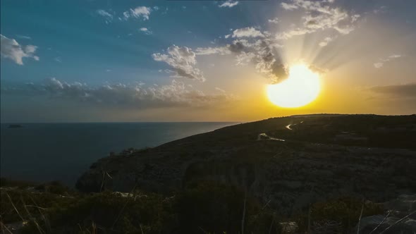Time lapse from Blue Grotto in Malta of golden sunset over Meditteranean alt