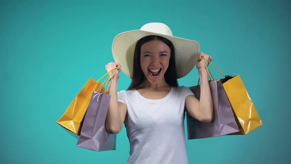 Cheerful Asian Girl in Panama Holding Many Paper Bags, Shopping, Womens Hobby alt