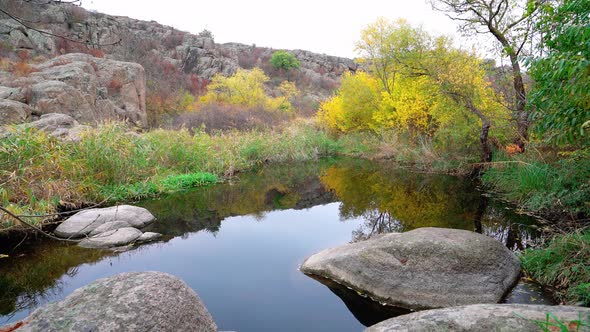 A Fast Clean Stream Runs Among Smooth Wet Stones Surrounded By Tall Dry Lumps alt