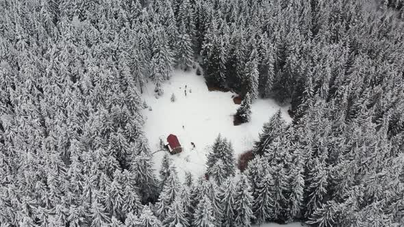 Drone Circle Over Mountain Valley With a Log Cabin 