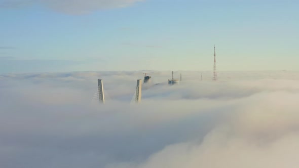 Tops of the Pylons of the Golden Bridge in the Dawn Fog in Vladivostok alt