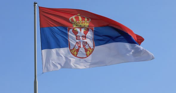 Serbian national flag on wind, outdoor