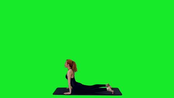 Sporty Female Stretching During Yoga On Mat Against Green Screen