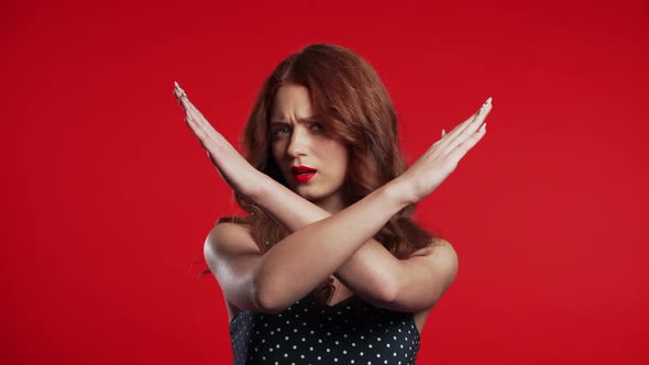 Cute Girl Disapproving with No Crossing Hands Sign Make Negation gesture alt