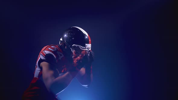 Portrait of Determined Professional American Football Player in Helmet in Bright Stadium alt