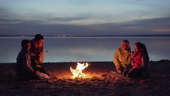 Family Dinner By Campfire on Beach at Night alt