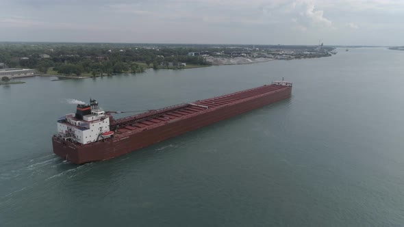 This video is of an aerial of large tanker ships in the Detroit river near downtown Detroit. alt