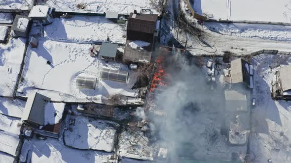Top View The House is Engulfed in Flames with Orange Flames and Smoke