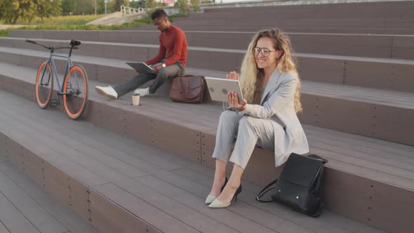 Young Business People with Gadgets Working Outdoors alt