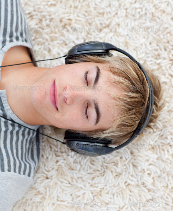 Teen guy listening to music - Stock Photo - Images