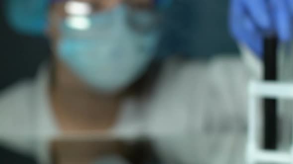 Professional Biochemist Analyzing Black Liquid in Test Tube, Oil Expertise, Lab alt