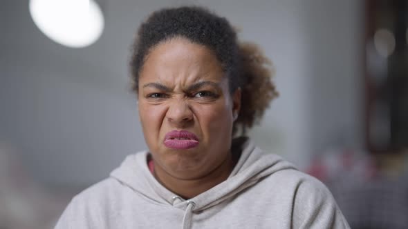 Closeup Portrait of African American Woman with Disgust Facial Expression Closing Face with Hands alt