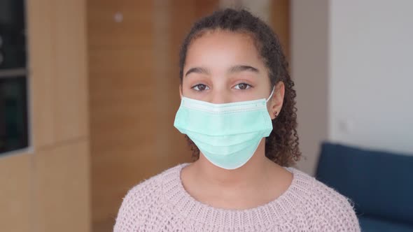 Closeup Portrait of Sad Afro American Girl Staying at Home in Protective Mask alt