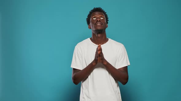 Man with Faith Praying to God Begging for Peace alt