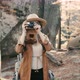 Active woman taking pictures with an vintage film camera on a forest rocks - VideoHive Item for Sale