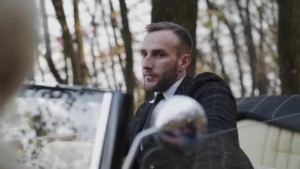 Handsome Man in Luxury Car Looking and Admiring the Girl alt