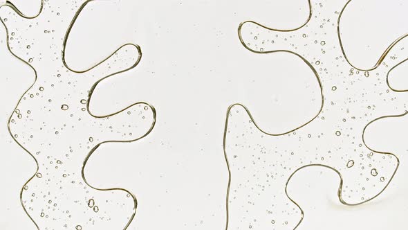 Transparent Cosmetic Gel Fluid with Bubbles Oil on Water Silver Colored Background alt