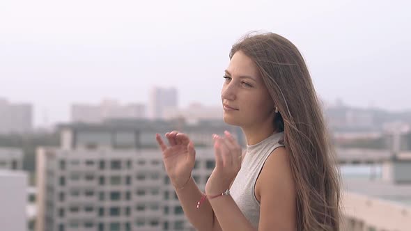 Happy Girl in Grey Dress Poses on Roof at Sunset Slow Motion alt