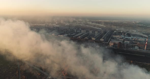 Aerial Drone Footage of Steel Factory Pipes During Sunset Time. High Above Metallurgical Plant  alt