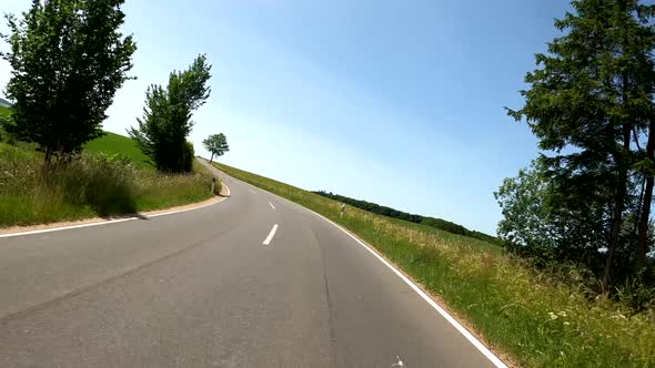 POV Driving on motorcycle on a scenic road in Eifel National Park in Germany alt
