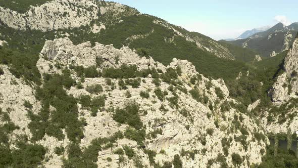 Aerial Revealing shot of a mountain on a hot summer day in Croatia. alt