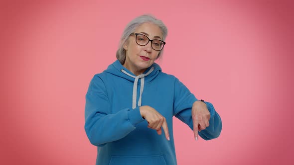 Senior Old Granny Woman Pointing Down Saying to Subscribe Gesturing Ok and Like Information Below alt