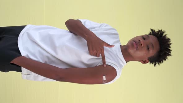 Vertical Video of African Teenager Showing COVID19 Vaccine Bandage Merrily alt