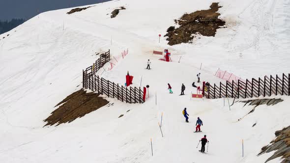 Winter sports, snowboarders on the marked downhill slope