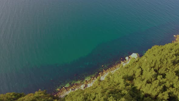 steep green mountains, deep forest and mountain road, beautiful valley and blue sea alt