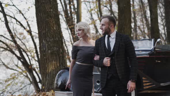 Portrait of Lovely Smiling Retro Couple Stands Together Under the Arms alt