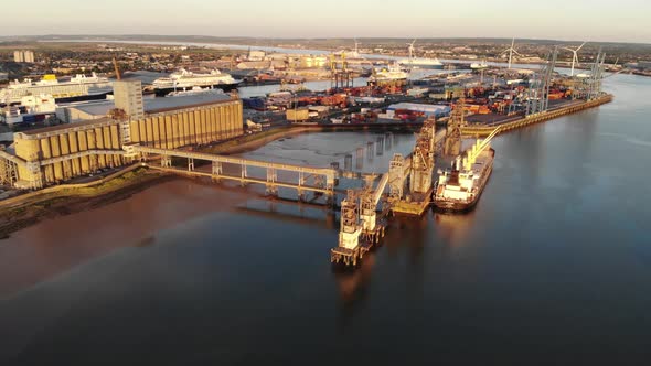 Aerial view of Port of Tilbury, with boats and cruise ships moored at sunset alt