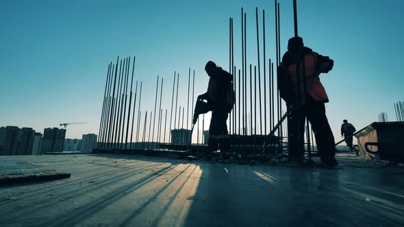 Workers Are Shoveling Off Pieces of Broken Concrete at the Building Lot alt