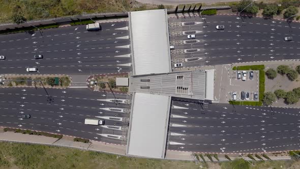 Toll road entrance and exit with traffic in both directions. alt