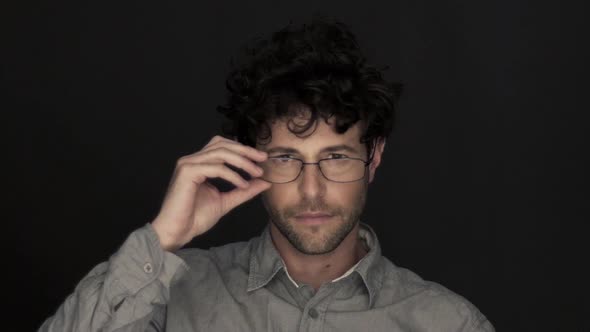 Man adjusting glasses, portrait alt